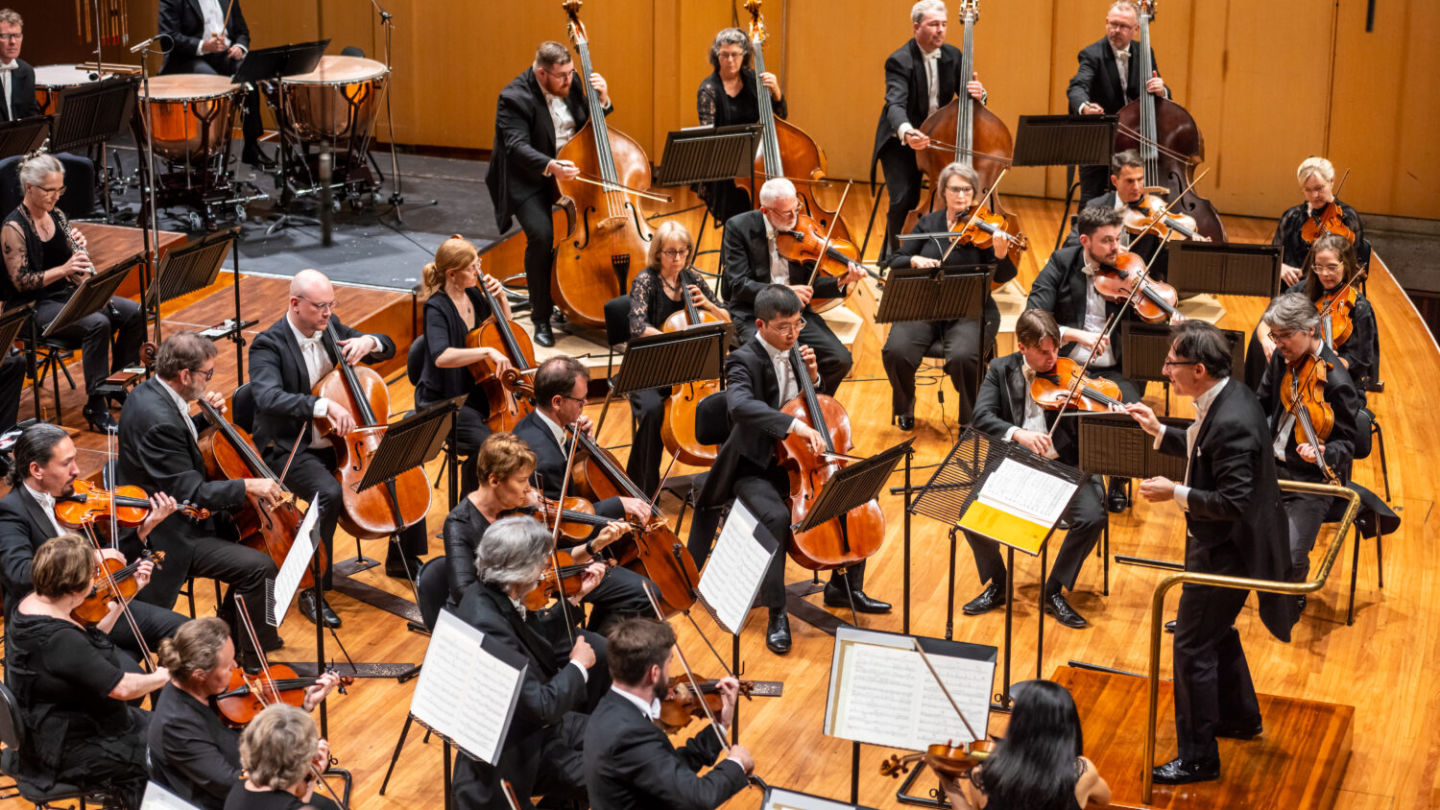 Orchestra and baton in swooning harmony